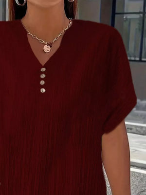Textured wine red v-neck t-shirt with decorative buttons and short sleeves.
