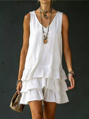 White tiered ruffled hem v-neck sleeveless dress with layered ruffles.