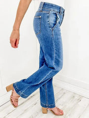 Medium wash denim jeans with wide legs and utility pockets.