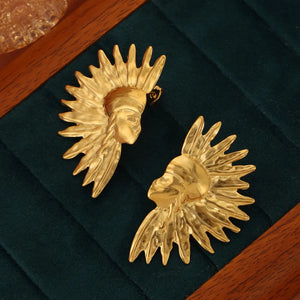 Gold sculptural earrings with sunburst and face details