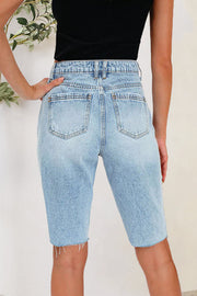 Light wash denim bermuda shorts with distressed hem detail