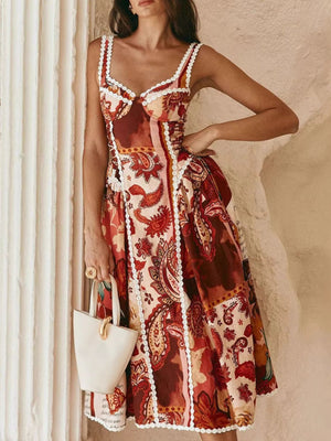 Midi dress with vintage paisley print, lace trim, sweetheart neckline, and tie straps.