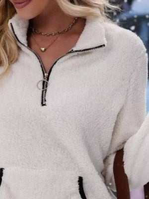 White fleece quarter zip pullover with black trim and ring zipper detail.