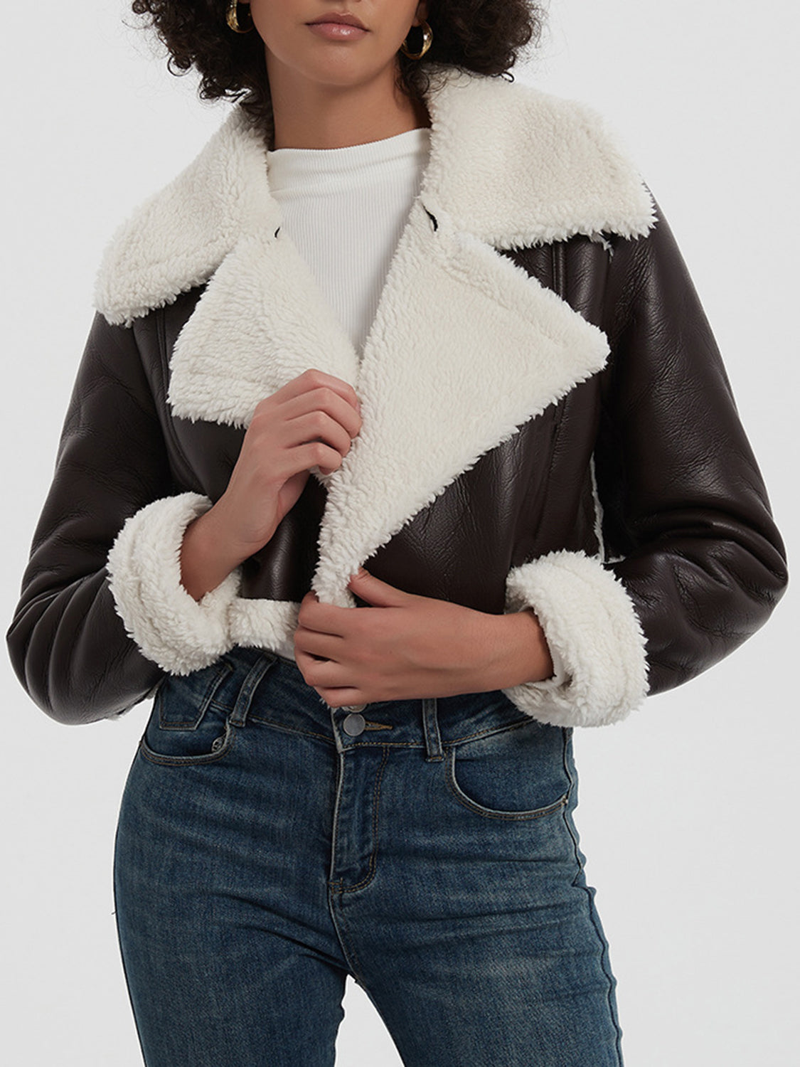 Brown cropped aviator jacket with white shearling trim and collar.