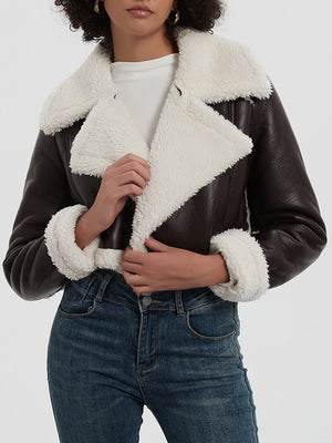Brown cropped aviator jacket with white shearling trim and collar.