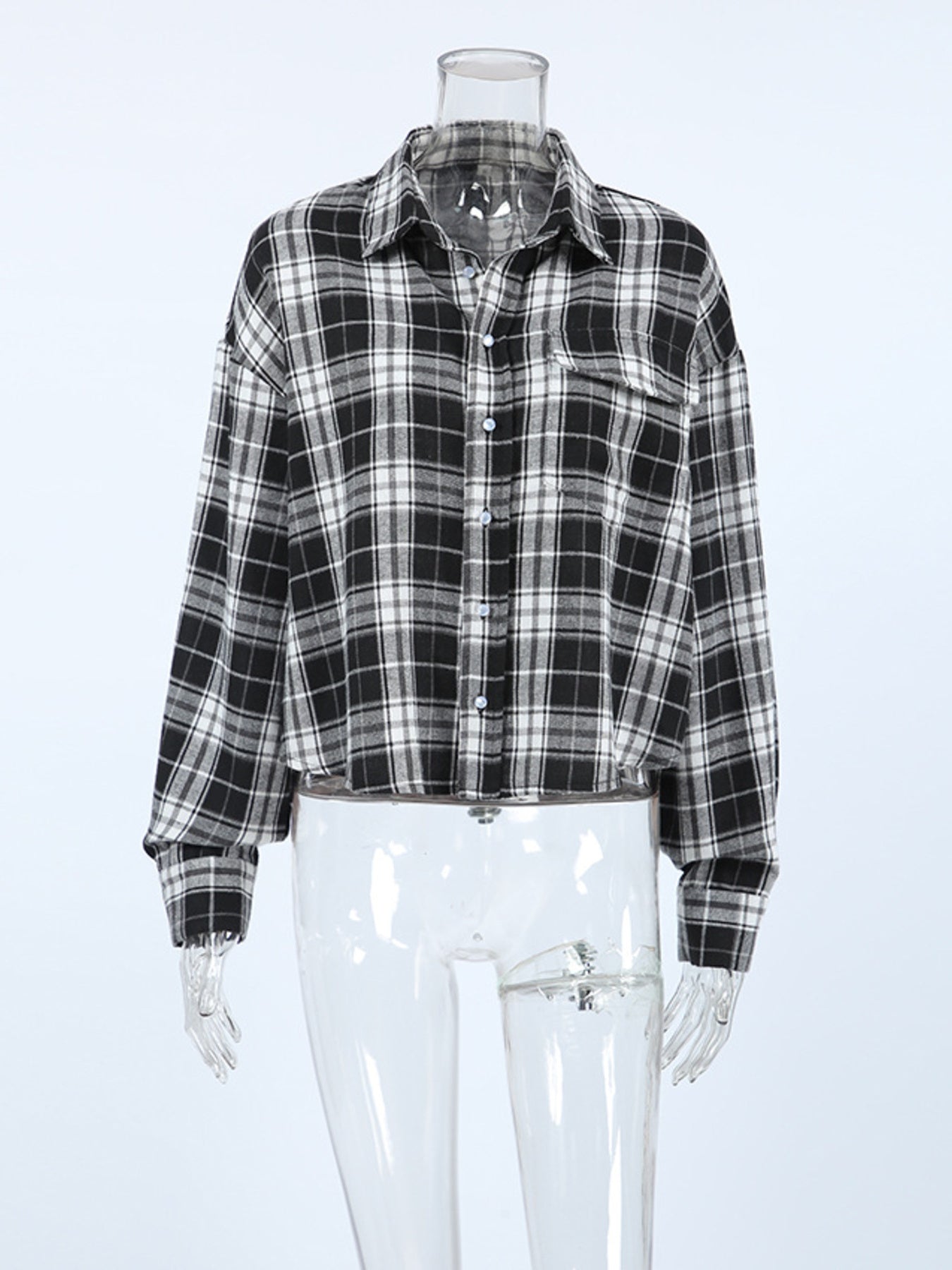 Oversized black and white plaid cotton button-up shirt with collar and chest pocket.
