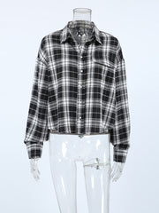 Oversized black and white plaid cotton button-up shirt with collar and chest pocket.