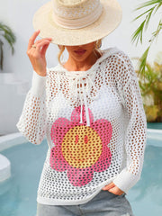 White knit hoodie with lace-up neckline and smiley flower graphic.