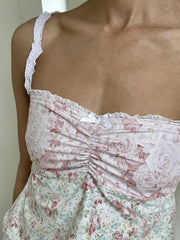 Pale blush mixed print camisole with ruching, lace trim, and lace straps.