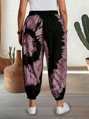 Tie-dye harem trousers with elastic waist in dusty pink and black, cropped length.
