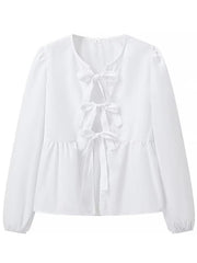 White tie-front peplum blouse with voluminous sleeves and bow details