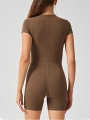 Brown short sleeve zip-front bodysuit with seam detail and short legs.