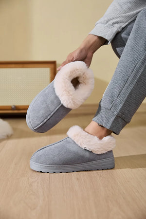 Gray suede slippers with plush shearling trim, slip-on style