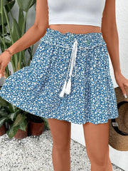Ditsy floral ruffle mini skirt in light blue with a drawstring and tassels.