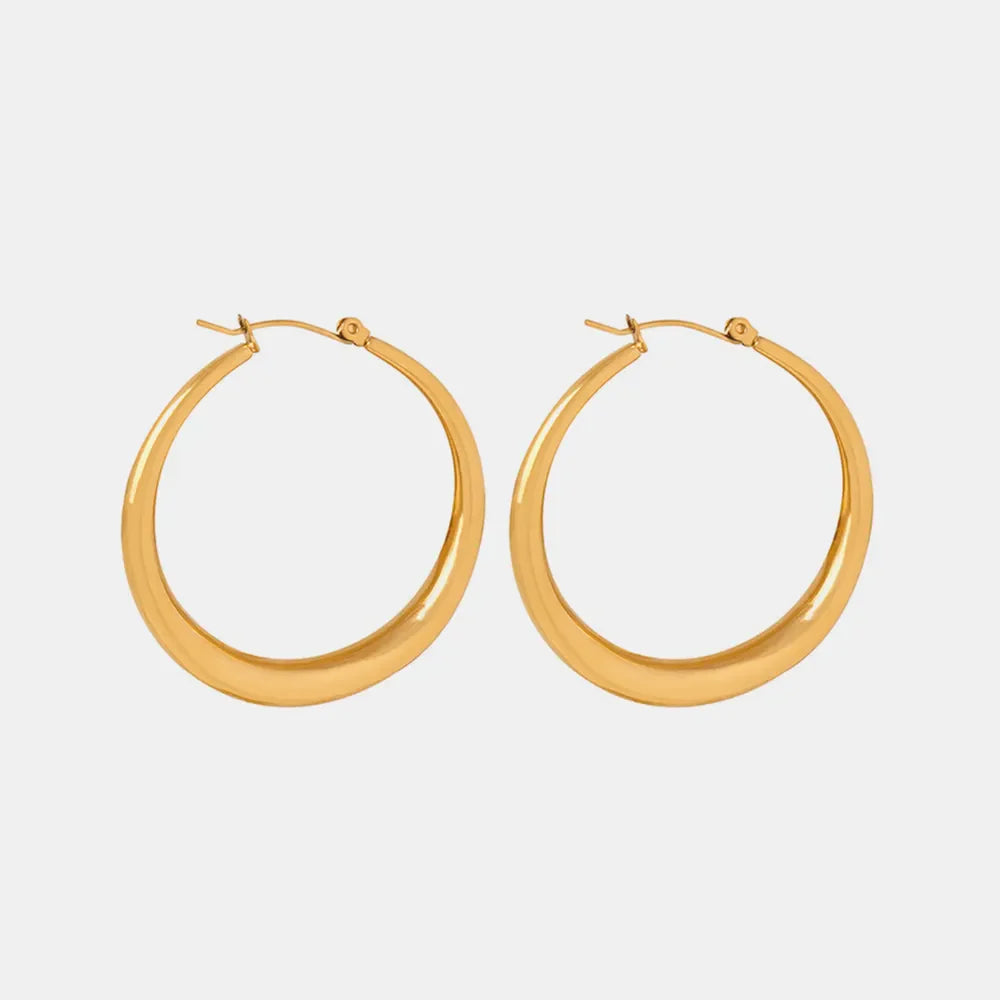 Sculpted oval gold hoop earrings with a polished finish.