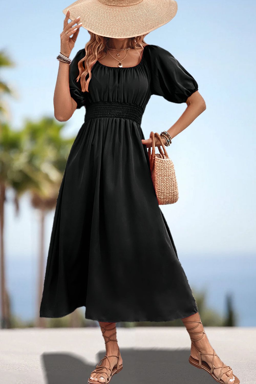 Black off-shoulder puff sleeve empire midi dress with smocked waist and A-line skirt.