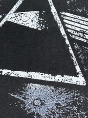 Black cotton blend t-shirt with a distressed white geometric graphic print.