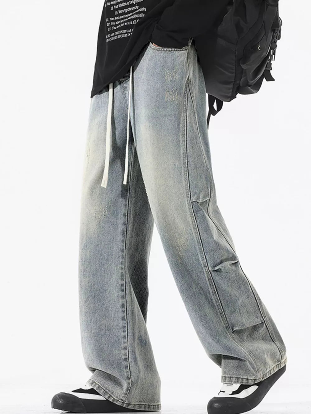 Light wash distressed wide leg jeans with drawstring and cargo pockets.
