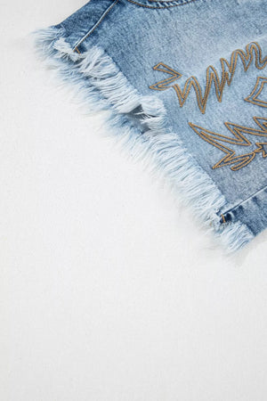 Light wash denim shorts with distressed frayed hem and gold western embroidery detail.