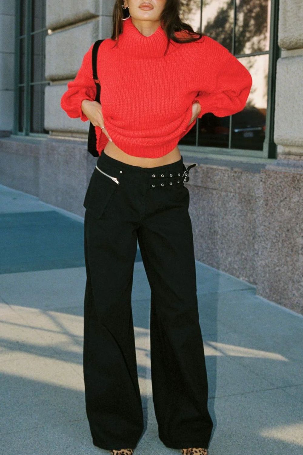 Black flared denim trousers with utility buckle and zip details