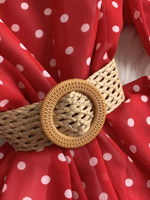 Red polka dot tiered dress with a woven circular belt detail.