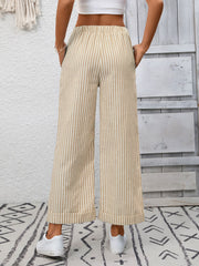 Drawstring wide leg pants in apricot with vertical stripes and pockets.