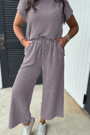 Gray ribbed knit drawstring co-ord set with cropped pants and short sleeve top.