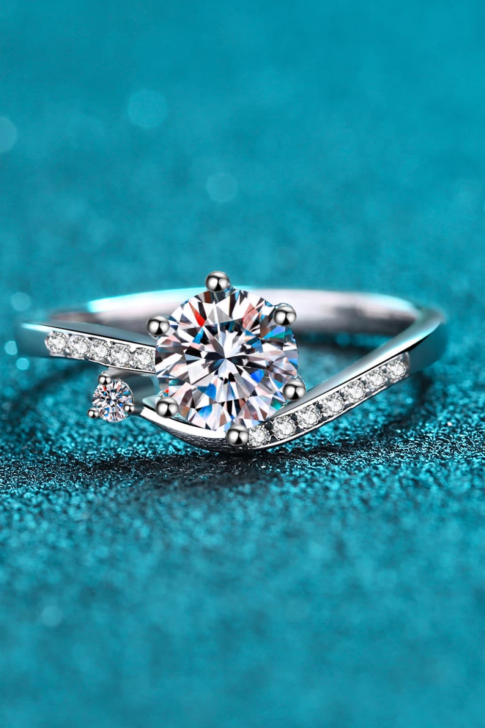 Silver bypass ring with a large center moissanite and pavé accents.