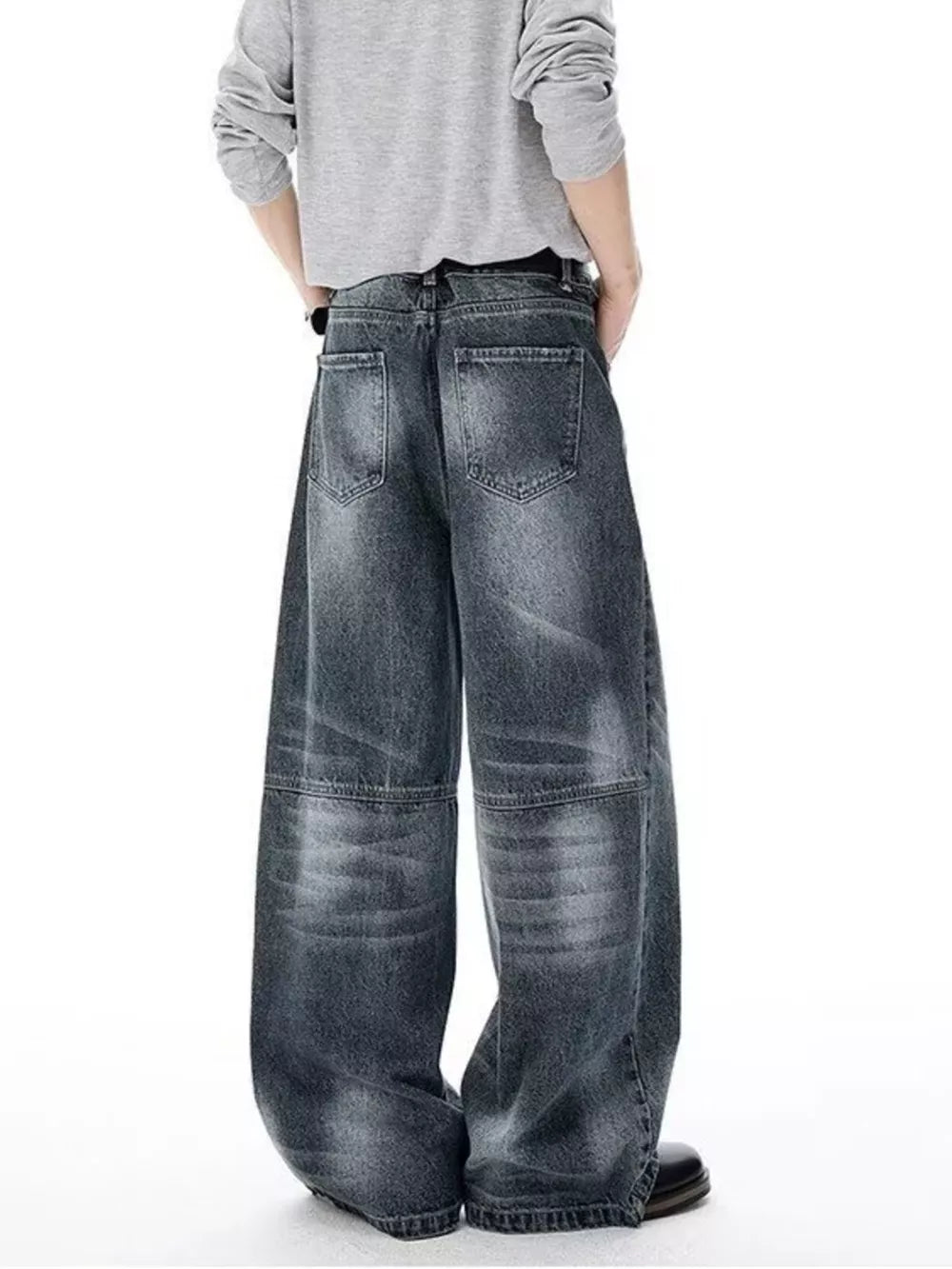 Men's dark wash wide-leg jeans with belted waist and vintage-inspired paneling.