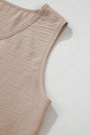 Camel sleeveless vest with textured fabric and a V-neckline.