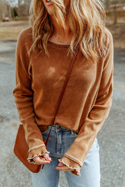 Caramel waffle knit raglan sweater with ruffled cuffs and contrast stitching.