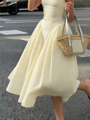 Plaid square neck midi dress in pastel yellow with a-line skirt and voluminous hem.