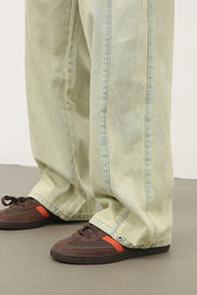 Acid wash wide leg denim trousers in sage with visible stitching detail.