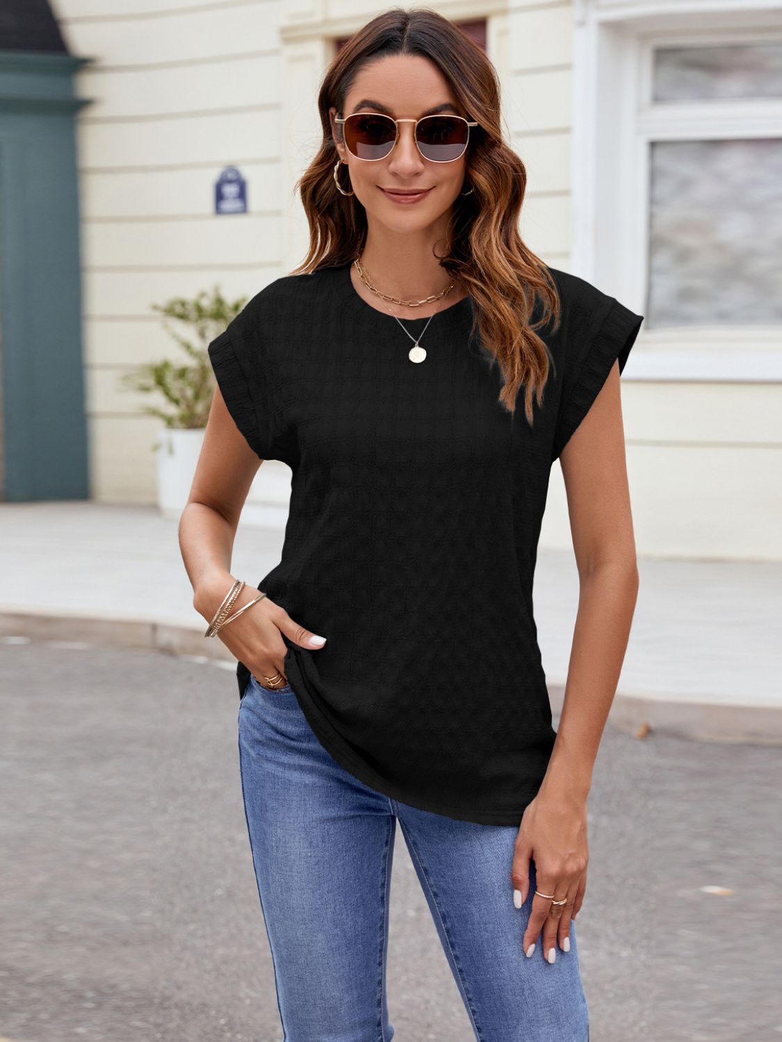 Black textured cap-sleeve tee with subtle knit and crew neck.