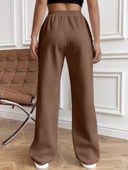 Brown pleated palazzo drawstring trousers with a relaxed fit.
