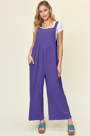 Ribbed wide-leg pinafore jumpsuit in Royal Blue with button straps and pockets.