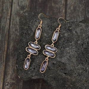 Gold Geometric Stone Cascade Earrings with dark faceted stones