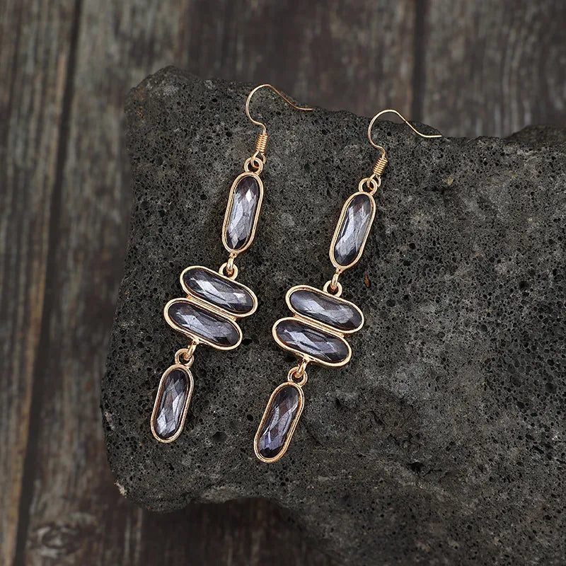 Gold Geometric Stone Cascade Earrings with dark faceted stones