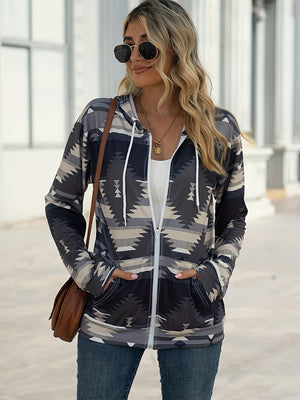 Aztec print zip-up hooded jacket in gray with white drawstrings and pockets.