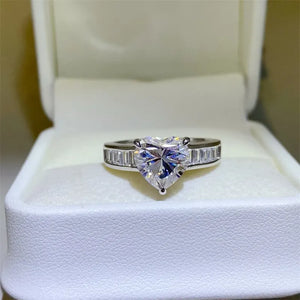 Silver ring with heart-cut moissanite and baguette band