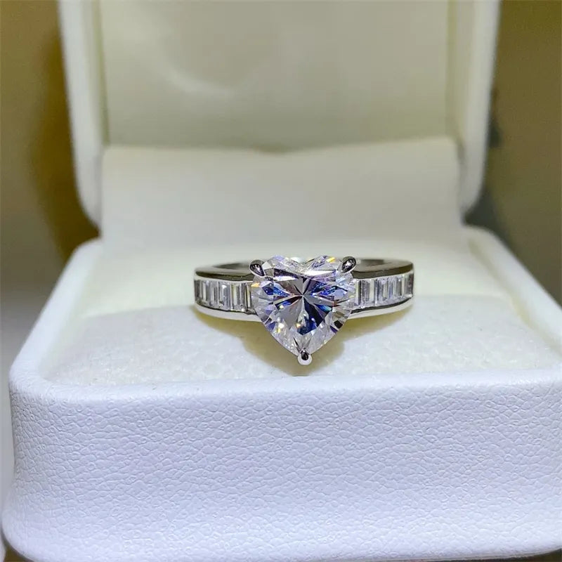 Silver ring with heart-cut moissanite and baguette band