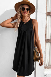 Black sleeveless trapeze dress with pleated yoke detail