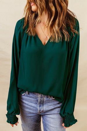 Green ruched cuff voluminous sleeve blouse with V-neck and long sleeves.
