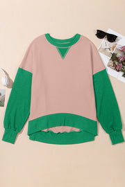Chic Contrast Crewneck Sweatshirt in pink with green sleeves and trim, featuring a V-stitch detail.