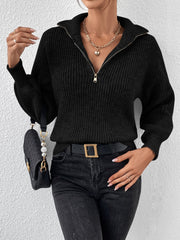Black ribbed zip-up knit sweater with a stand-up collar and balloon sleeves.