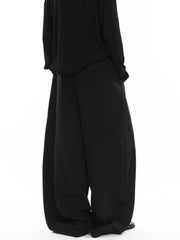 Men's black wide-leg sweatpants with drawstring and back pocket detail.