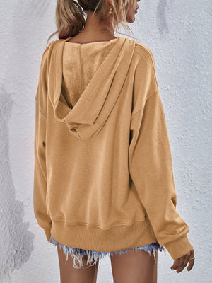 Tan boxy hooded sweatshirt with split hem and soft lining.