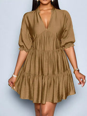 Brown tiered mini dress with notched V-neck and ruffled sleeves.