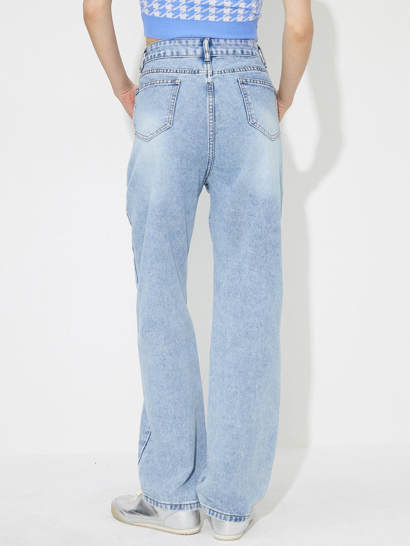 Light wash embroidered pocket denim jeans with a relaxed fit.