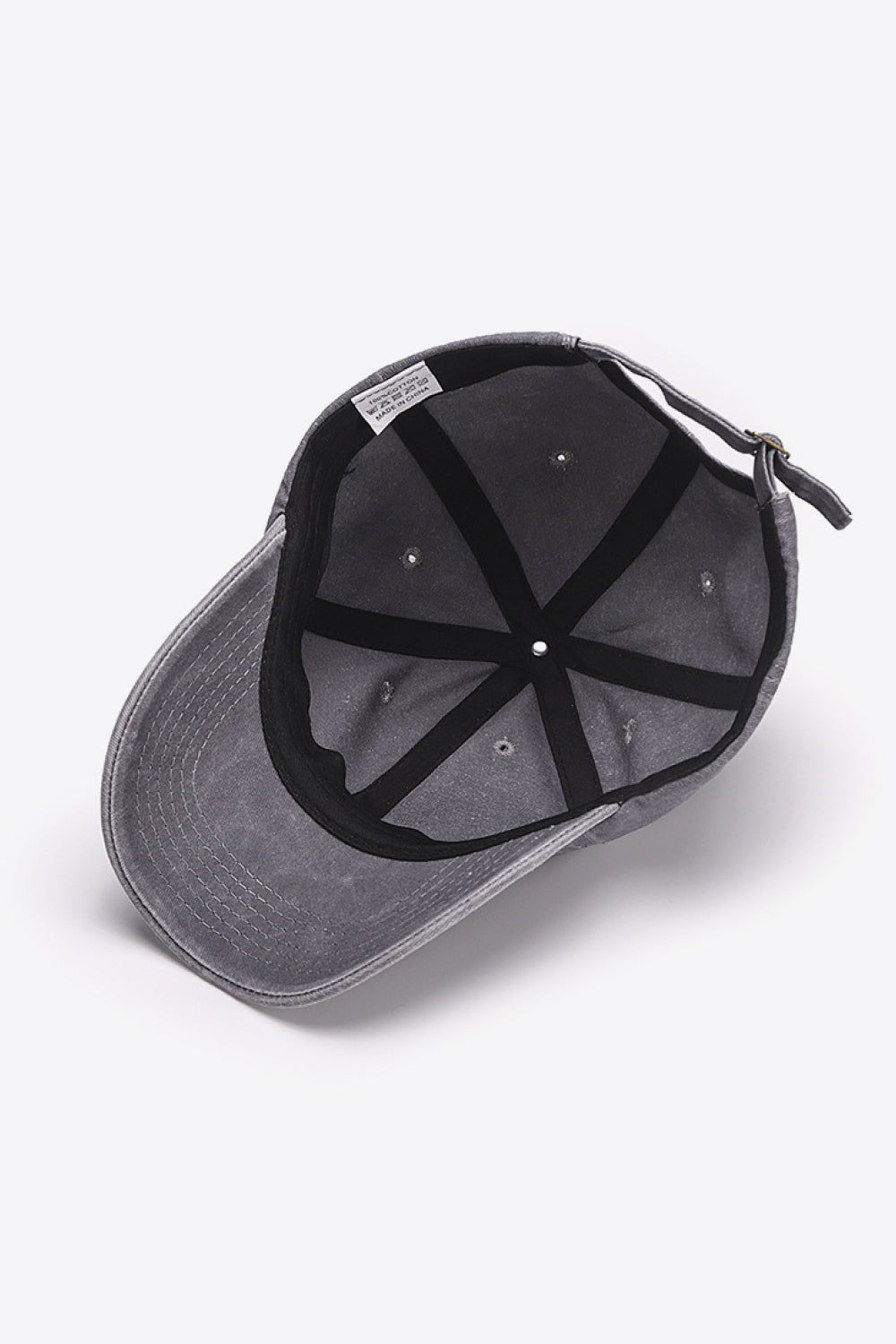 Washed cotton baseball cap in gray with adjustable strap and interior label.